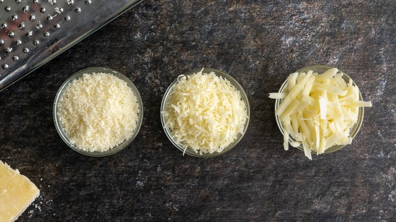 Bowls of differently grated cheese