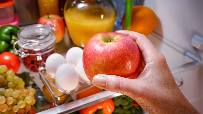 Taking an apple from the fridge