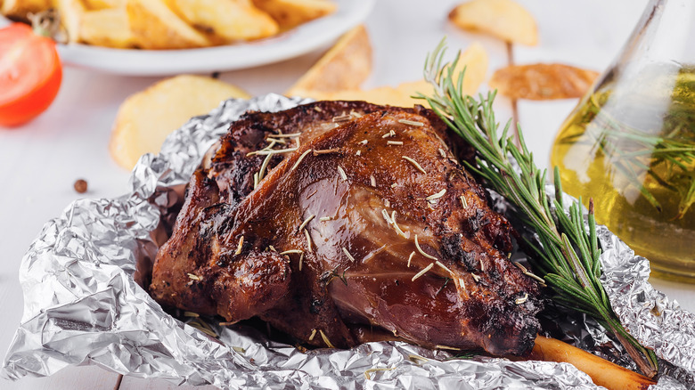 Roast lamb and potatoes on foil