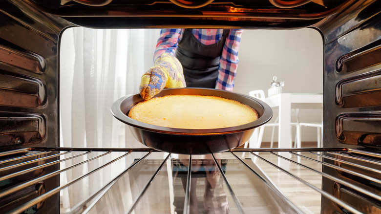 taking cheesecake out of oven