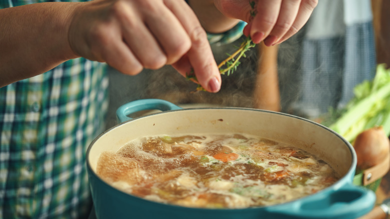 Adding ingredients to boiling broth