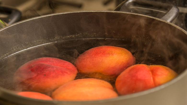 Peaches blanching in a pot