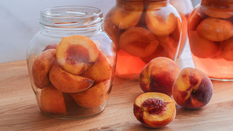 Jars of halved, pitted peaches