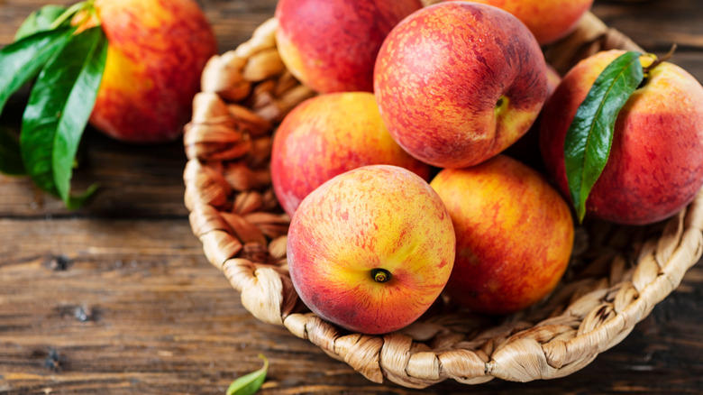 Basket of peaches on a table