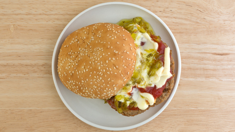 Cheeseburger with toppings on plate