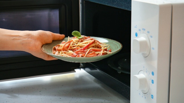 Plate of pasta and microwave