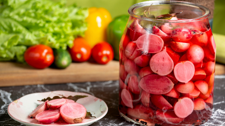 radishes in jar of water