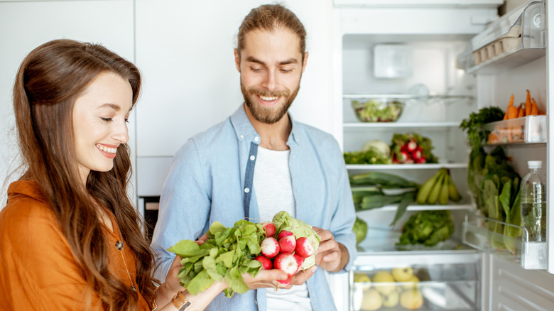 People holding radishes