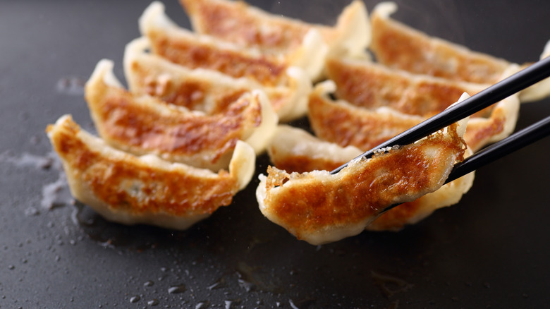 Crispy dumplings held by chopsticks