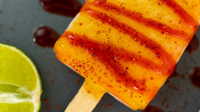 mango popsicle with tajin sprinkles