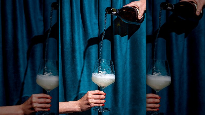 pouring champagne with curtain