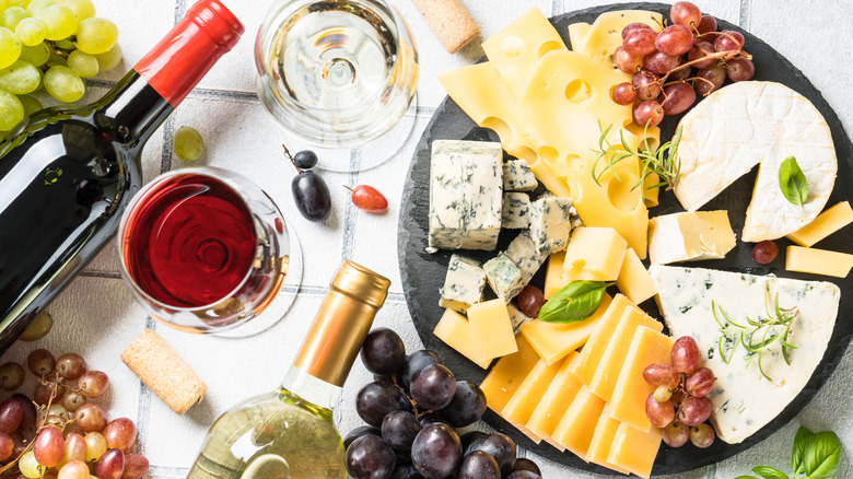 various cheeses and bottles of wine