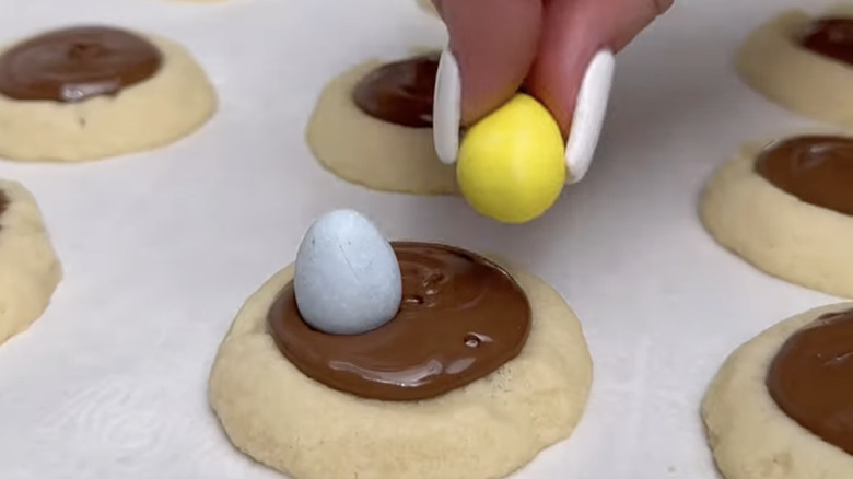 Cadbury mini eggs on thumbprint cookies