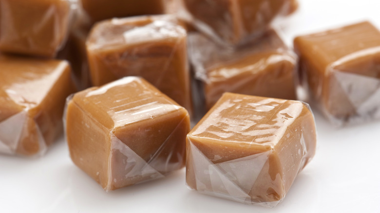 Several toffee candies wrapped in clear plastic