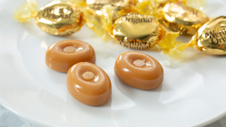 Werther's Original toffee candy on a white plate with gold wrappers