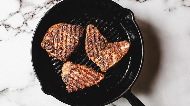 Grilled tuna steaks in a skillet