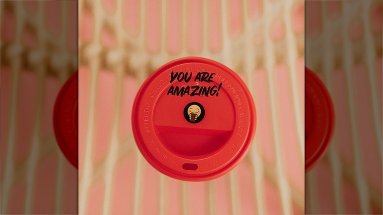 Coffee barista writing on cup