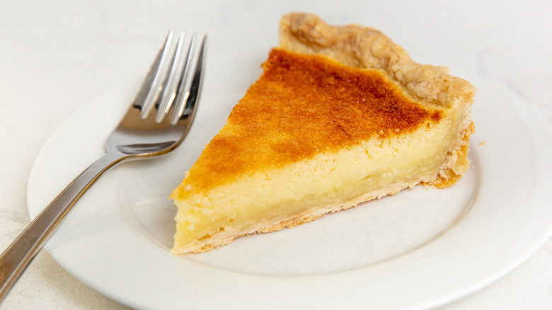 slice of buttermilk pie on white plate with silver fork