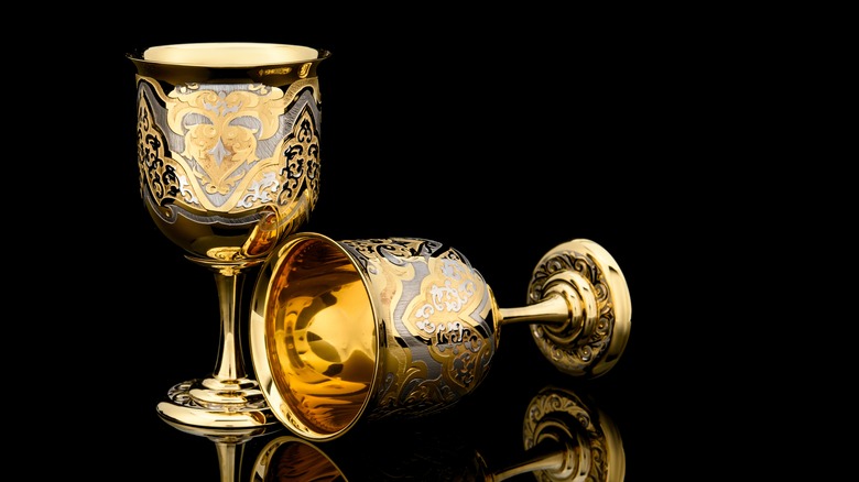 Two decorated golden goblets