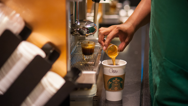 barista pouring coffee drink