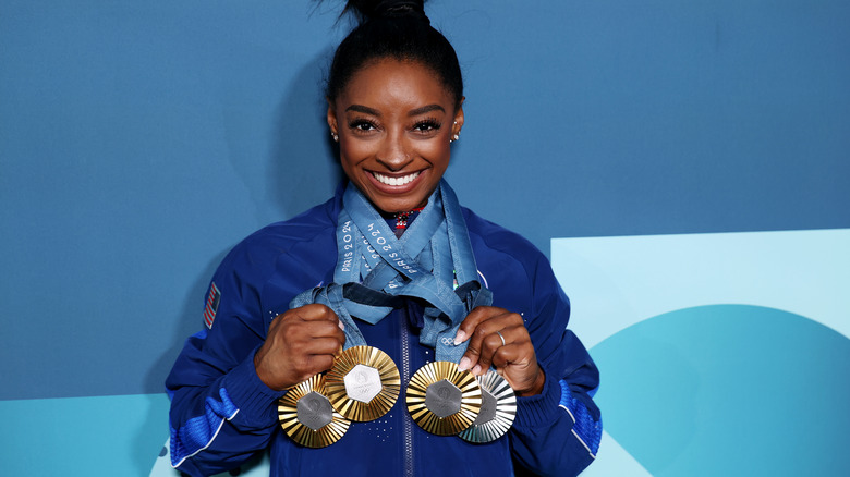 Simone Biles with Olympic medals