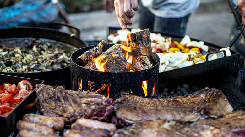 barbecue fire pit surrounded by different ingredients