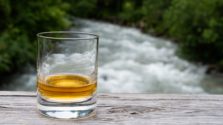 whisky closeup with river in background 