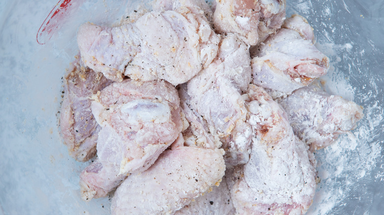 dredging chicken wings in baking soda and flour