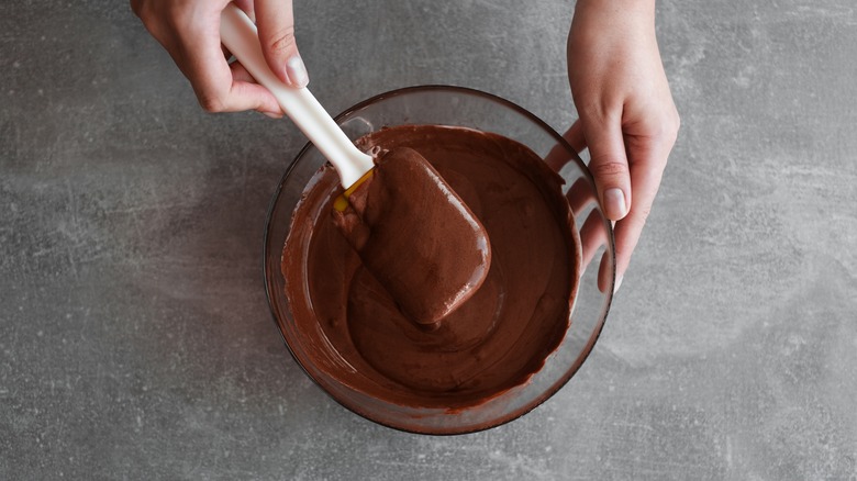 Hands preparing a chocolate mousse