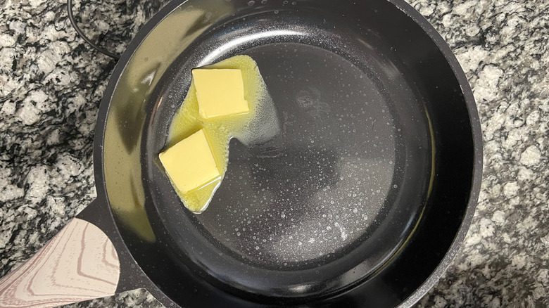 butter cubes melting in skillet