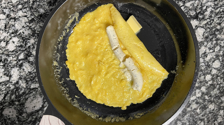 butter with omelette in pan