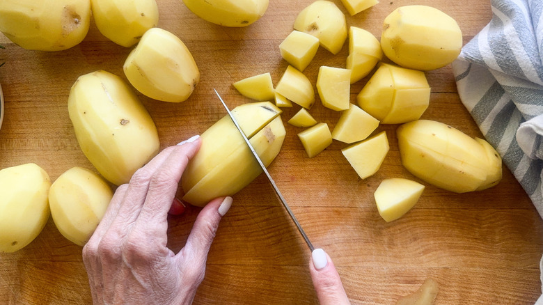 hands chopping the potatoes