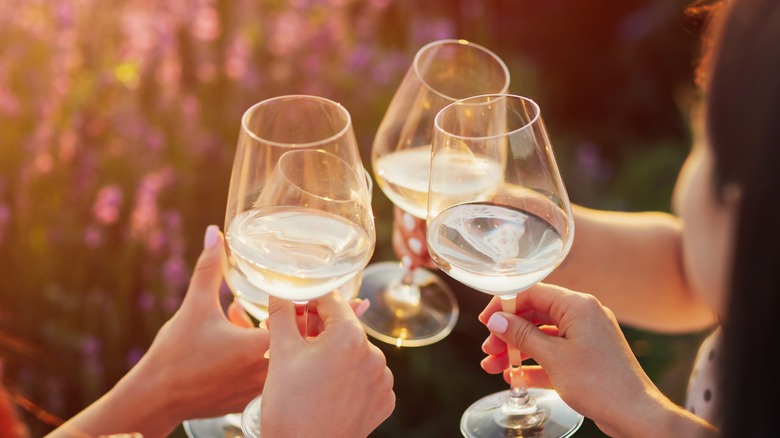 People toasting wine glasses