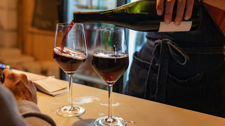 Pouring red wine in glass