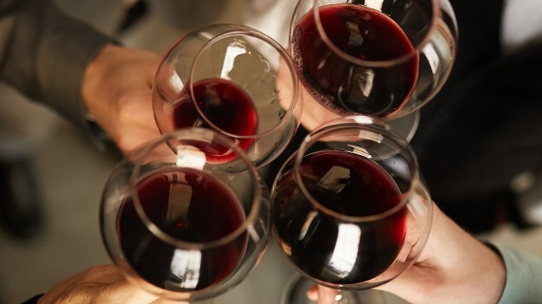 People toasting pinot noir glasses