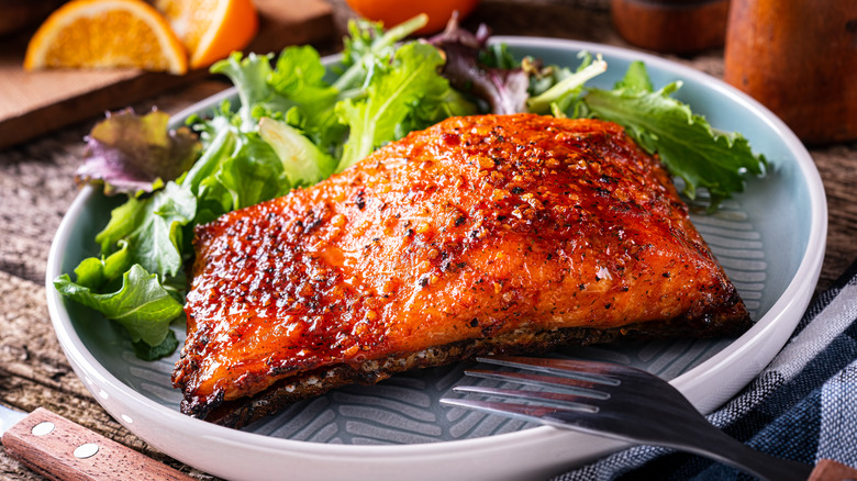 Glazed salmon on a plate with lettuce