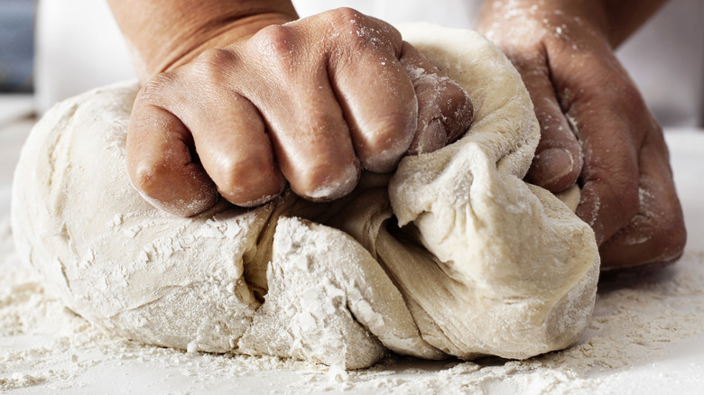 hands kneading dough