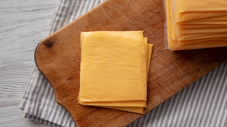 cheese slices on wooden board