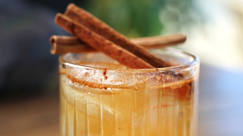 Close-up of a drink garnished with cinnamon sticks