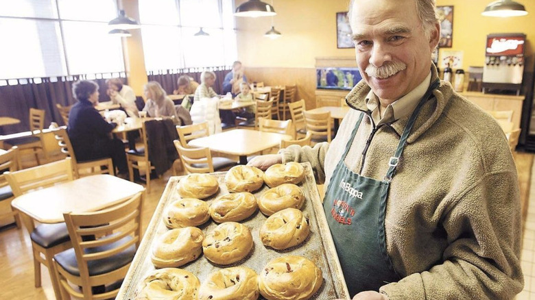 Man holding tray of bagels