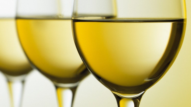 Close-up of three glasses of white wine