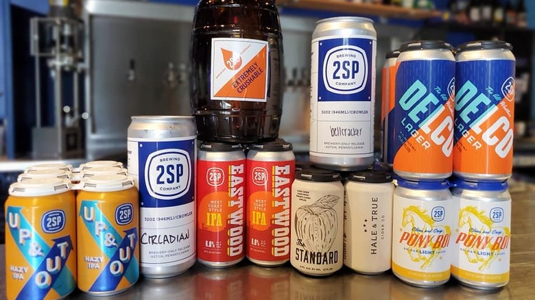 2SP Brewing Company cans and growler on counter