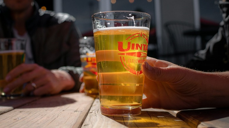 Uinta Brewing glass on wood table