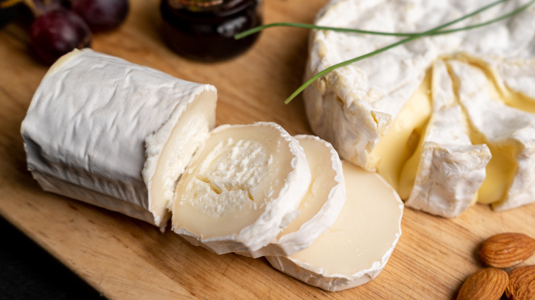 sliced log of goat cheese on a board 