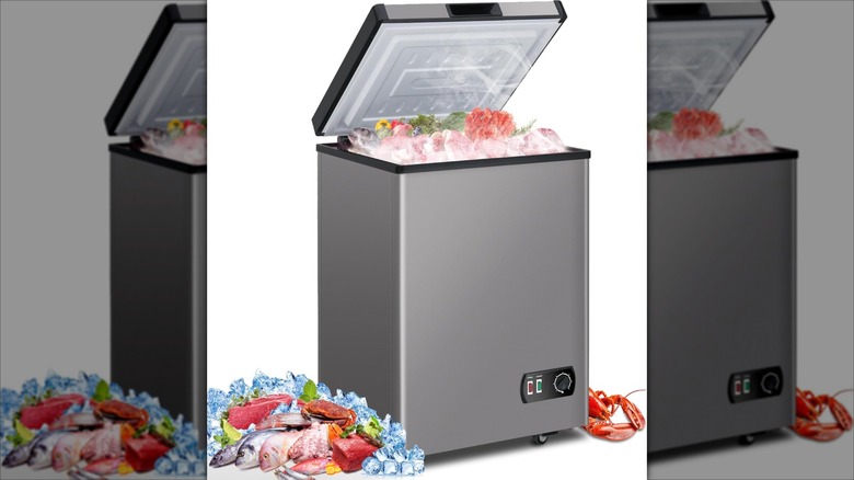 LifePlus 3.8 cubic feet chest freezer with raw fish inside and on the side on white background