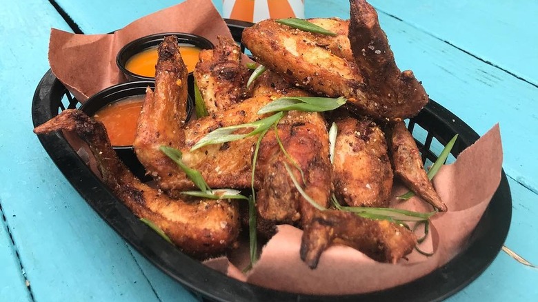 Fresh chicken wings in basket