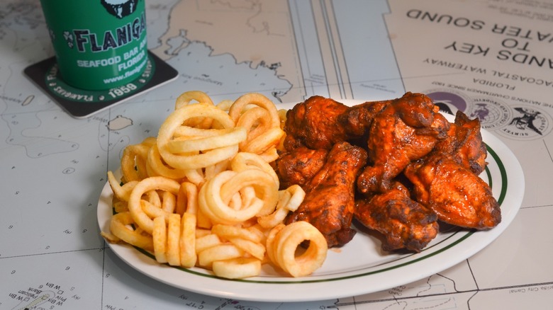 plate of wings with curly fires