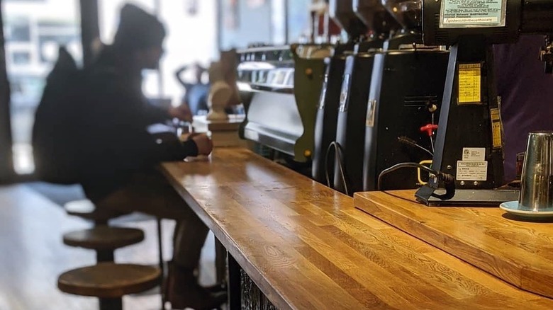 The Wormhole Coffee Chicago person sitting at counter