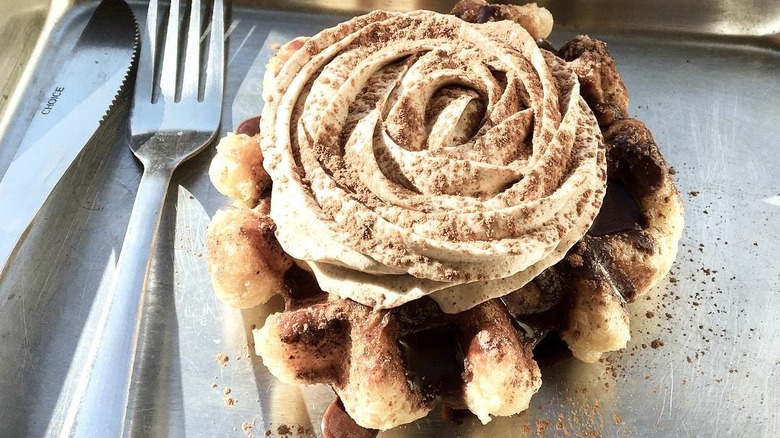 Curio Coffee Boston waffle on metal tray with knife and fork