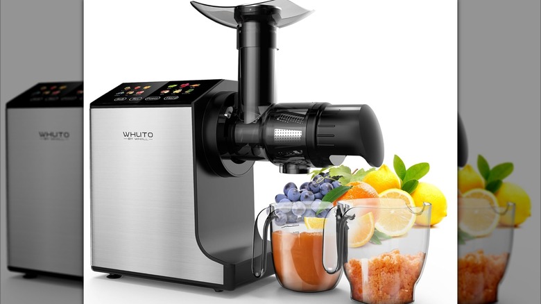 Whuto Cold Press Juicer with glasses of juice and pulp on white background